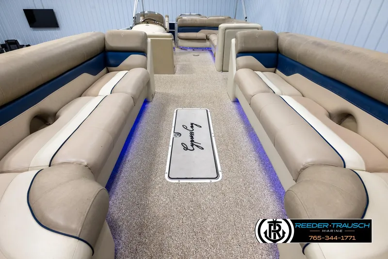 Slide: The Image of Interior of 2012 Cypress Cay 250 Cozumel pontoon boat with beige seating and blue accents. - 13