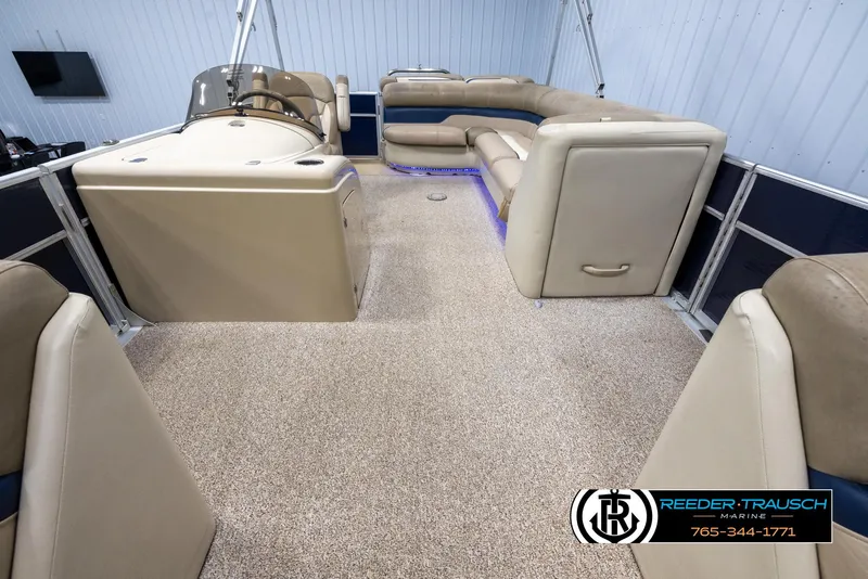 Slide: The Image of 2012 Cypress Cay 250 Cozumel pontoon boat interior with beige seating and carpeted floor. - 14
