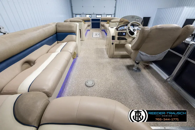 Slide: The Image of 2012 Cypress Cay 250 Cozumel pontoon boat interior with beige seating and modern dashboard. - 16