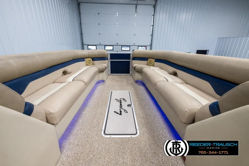 Slide: The Image of Interior of 2012 Cypress Cay 250 Cozumel boat with beige seating and blue accents. - 19