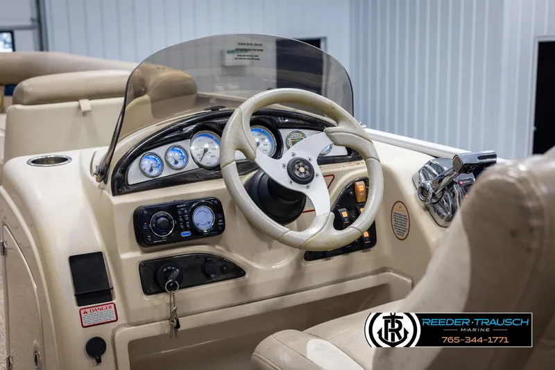 Slide: The Image of 2012 Cypress Cay 250 Cozumel boat dashboard with steering wheel and gauges. - 29