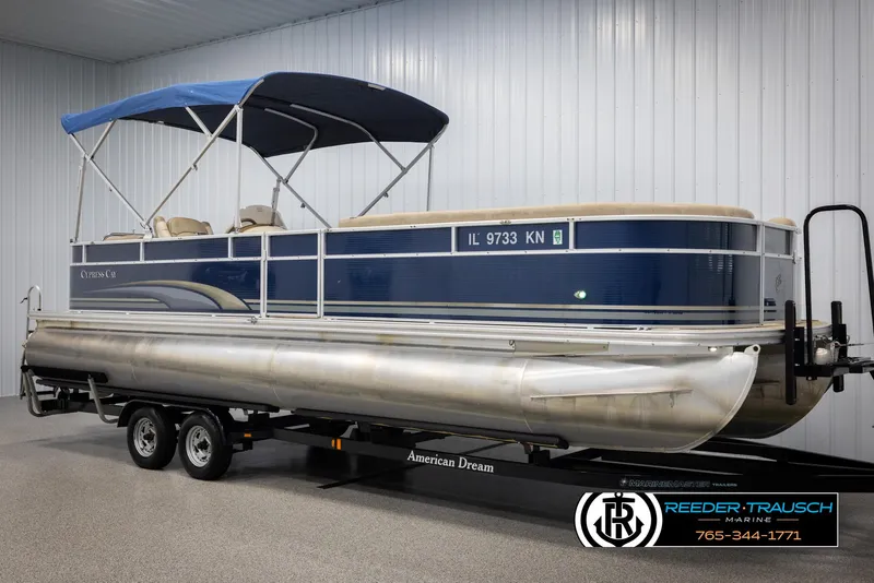 Slide: The Image of 2012 Cypress Cay 250 Cozumel pontoon boat on trailer in indoor storage. - 3