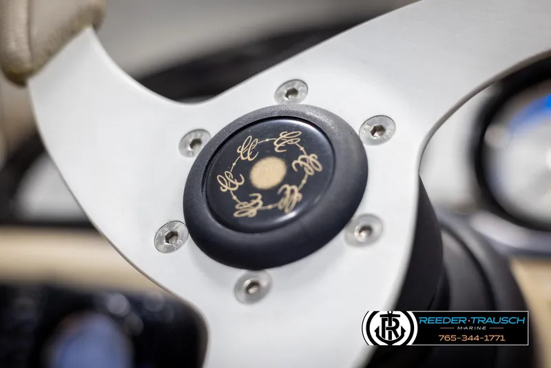 Slide: The Image of Steering wheel of 2012 Cypress Cay 250 Cozumel boat, featuring logo and emblem details. - 30