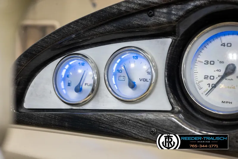 Slide: The Image of Dashboard gauges of a 2012 Cypress Cay 250 Cozumel boat, showing fuel and voltage levels. - 32