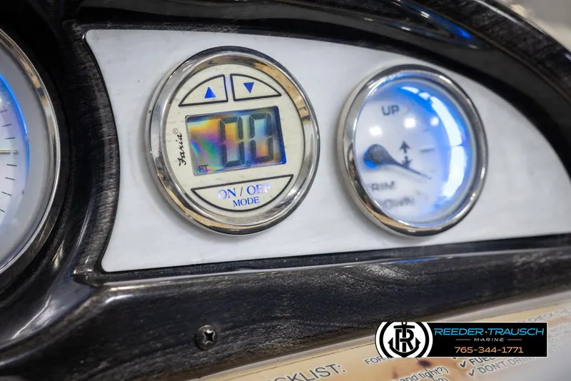 Slide: The Image of Dashboard of 2012 Cypress Cay 250 Cozumel boat with digital and analog gauges. - 35