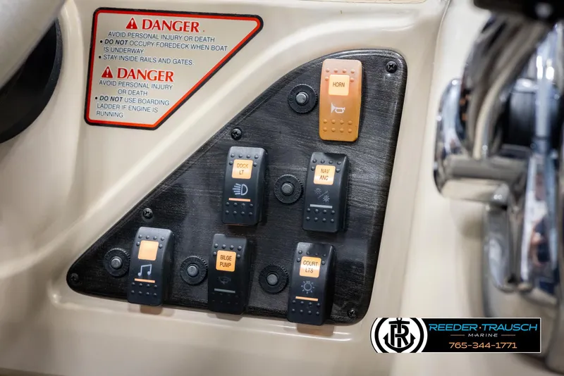 Slide: The Image of Control panel of a 2012 Cypress Cay 250 Cozumel boat with labeled switches and warning signs. - 36