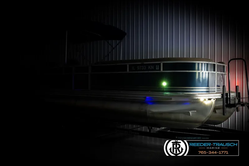 Slide: The Image of 2012 Cypress Cay 250 Cozumel pontoon boat in dimly lit storage. - 4