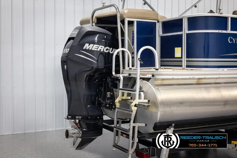 Slide: The Image of 2012 Cypress Cay 250 Cozumel pontoon boat with Mercury outboard motor in a showroom. - 44