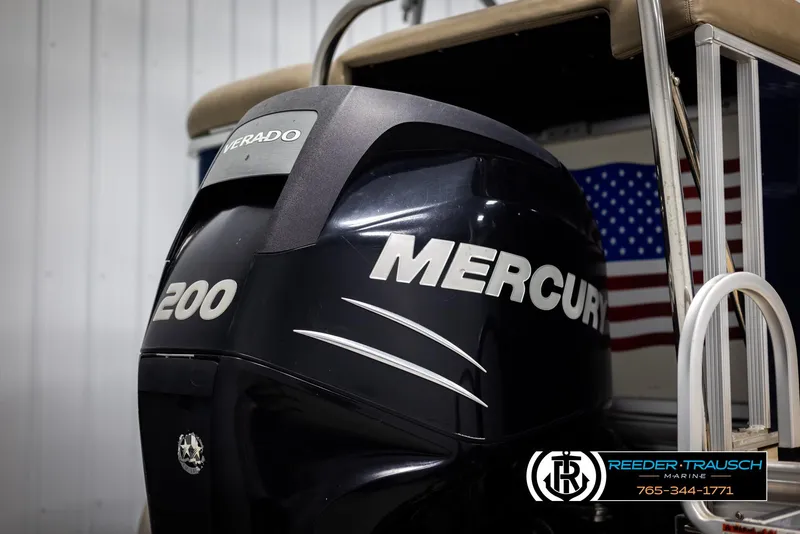 Slide: The Image of 2012 Cypress Cay 250 Cozumel with Mercury 200 outboard motor, American flag in background. - 45