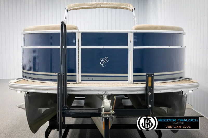 Slide: The Image of 2012 Cypress Cay 250 Cozumel pontoon boat, blue exterior, displayed indoors. - 8