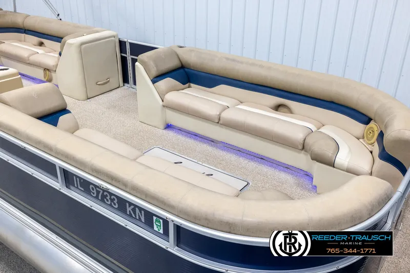 Slide: The Image of 2012 Cypress Cay 250 Cozumel pontoon boat with beige seating and blue accents. - 9