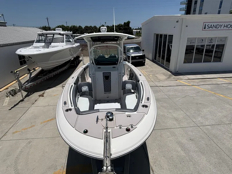 Slide: The Image of 2019 Wellcraft 262 Fisherman boat displayed outdoors at a dealership. - 11