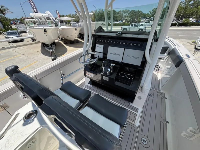 Slide: The Image of 2019 Wellcraft 262 Fisherman boat interior with dual Garmin displays and sleek seating. - 4