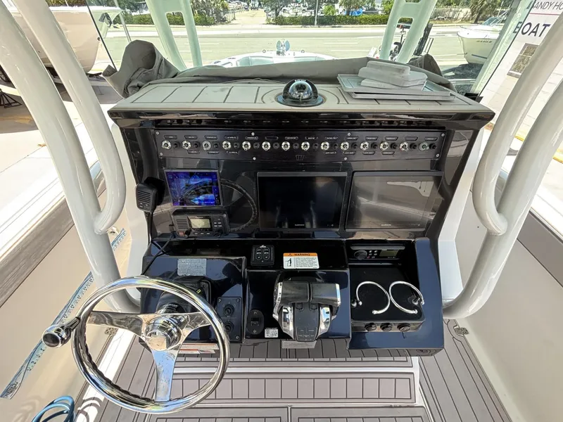 Slide: The Image of 2019 Wellcraft 262 Fisherman boat dashboard with steering wheel and control panel. - 5