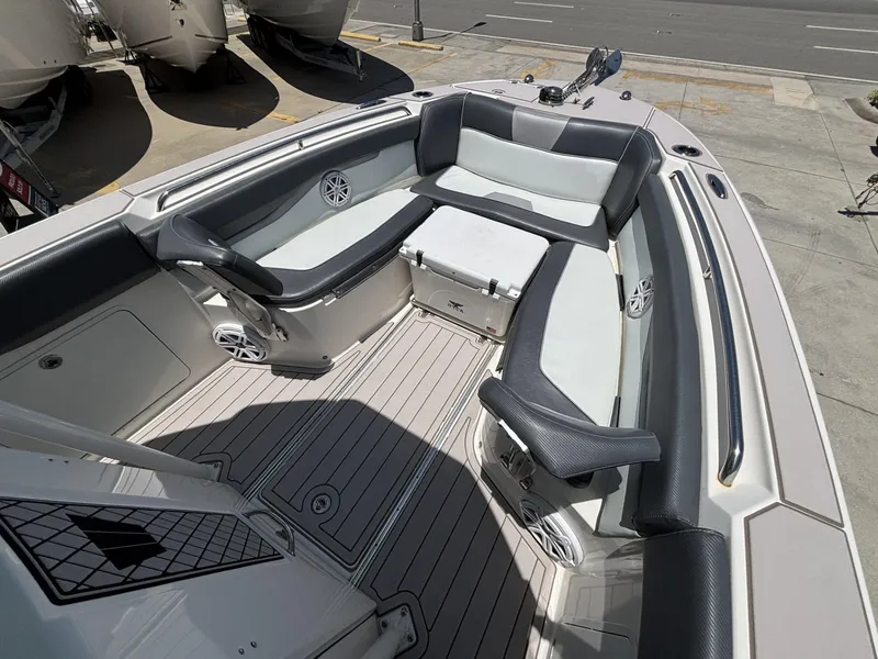Slide: The Image of 2019 Wellcraft 262 Fisherman boat interior with cushioned seating and storage. - 7