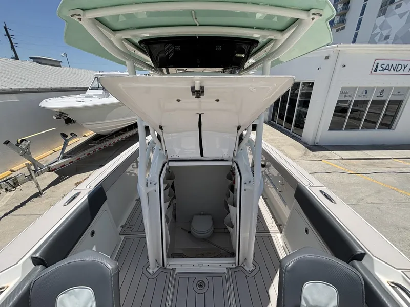 Slide: The Image of 2019 Wellcraft 262 Fisherman boat interior with open storage compartment and seating. - 8