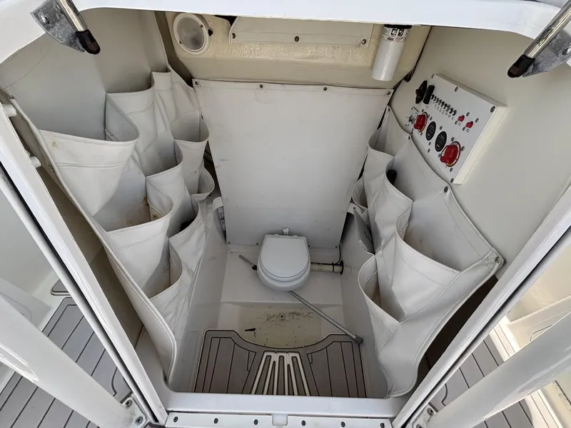 Slide: The Image of Interior of 2019 Wellcraft 262 Fisherman boat with storage and control panel. - 9