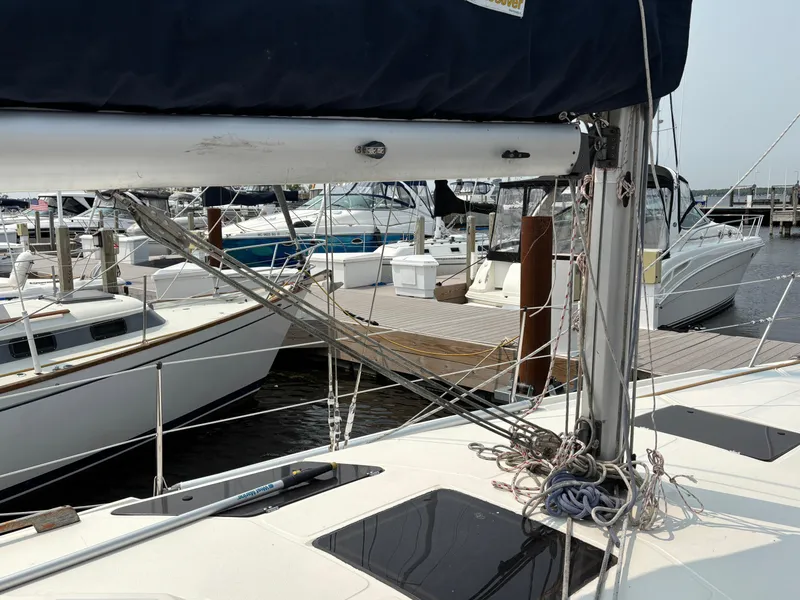 Slide: The Image of Hunter 33.5 sailboat from 1990 docked at a marina with other boats. - 11