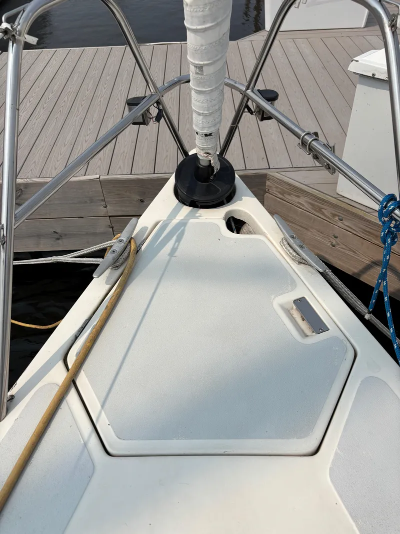 Slide: The Image of Bow of a 1990 Hunter 33.5 sailboat docked at a marina. - 12