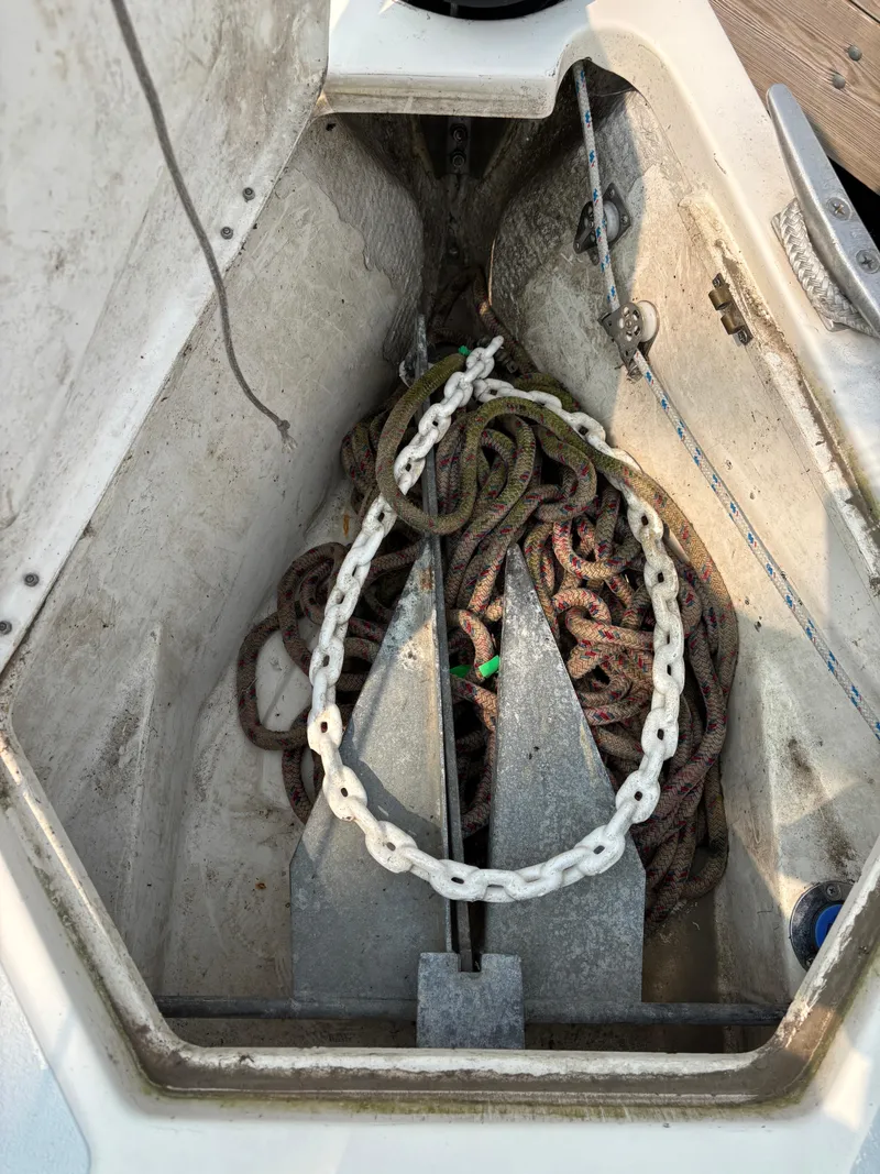 Slide: The Image of Anchor locker of 1990 Hunter 33.5 sailboat with ropes and chain. - 13