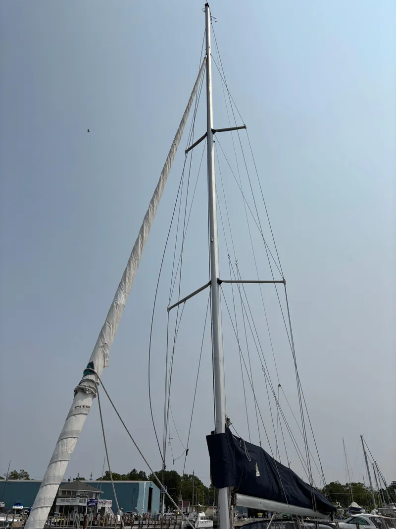 Slide: The Image of 1990 Hunter 33.5 sailboat mast and rigging against clear sky. - 2