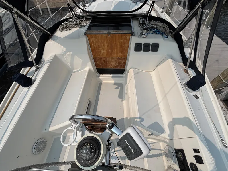 Slide: The Image of Cockpit of a 1990 Hunter 33.5 sailboat with steering wheel and navigation equipment. - 20