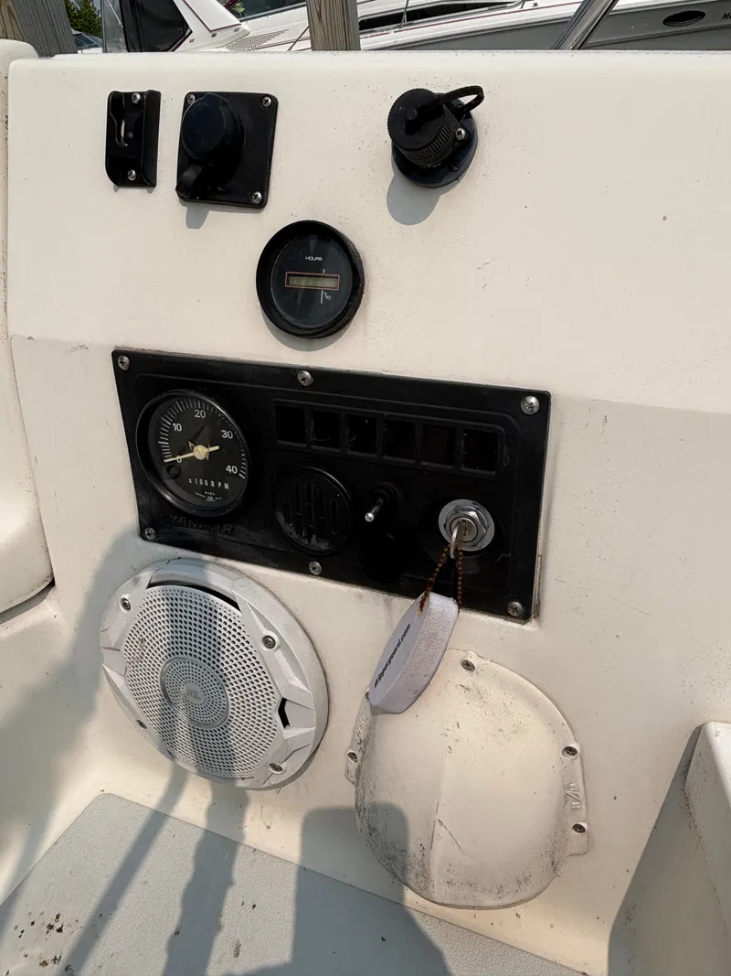 Slide: The Image of Control panel of a 1990 Hunter 33.5 boat with gauges and speaker. - 24