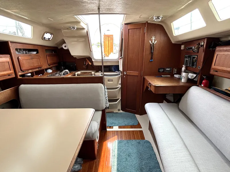 Slide: The Image of Interior of a 1990 Hunter 33.5 sailboat with wood finishes and seating area. - 38