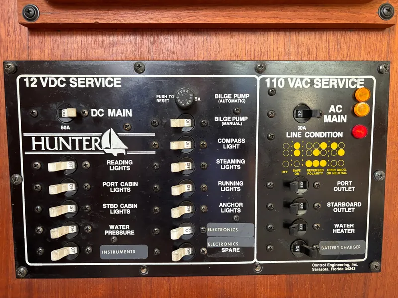 Slide: The Image of Electrical control panel of a 1990 Hunter 33.5 boat, featuring 12 VDC and 110 VAC services. - 40