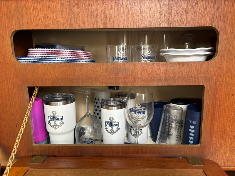 Slide: The Image of Cabinet with assorted drinkware and plates on a 1990 Hunter 33.5 sailboat. - 48