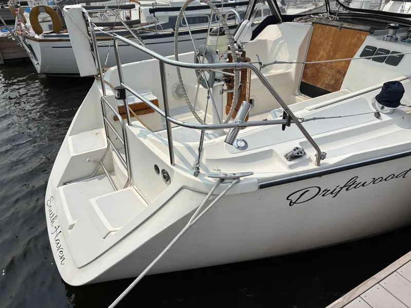 Slide: The Image of Hunter 33.5 sailboat from 1990, named Driftwood, docked at a marina. - 7
