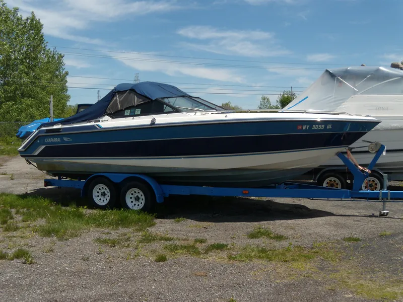 Slide: The Image of 1989 Chaparral 2300 SX Sport boat on trailer, parked outdoors. - 0