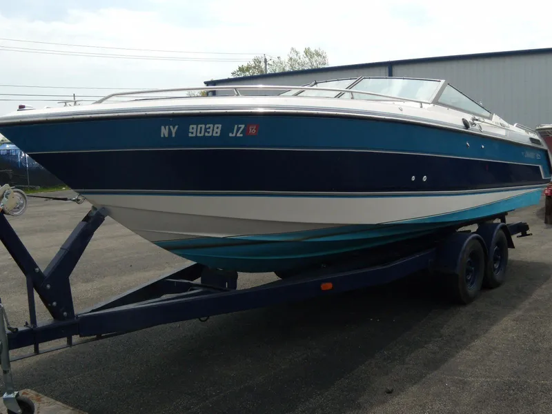 Slide: The Image of 1989 Chaparral 2300 SX Sport boat on trailer, blue and white exterior. - 1