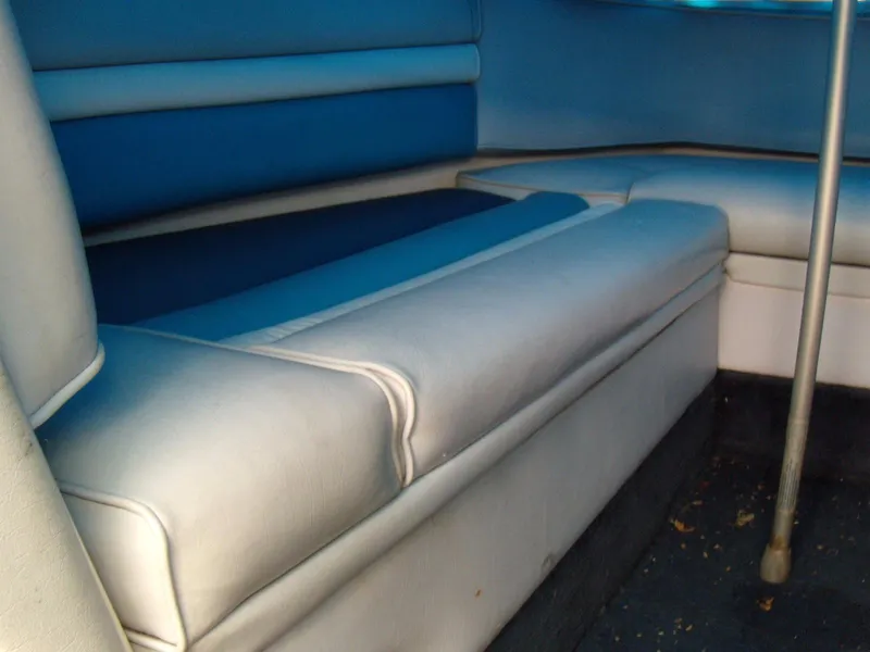 Slide: The Image of 1989 Chaparral 2300 SX Sport boat interior seating, featuring blue and white upholstery. - 13