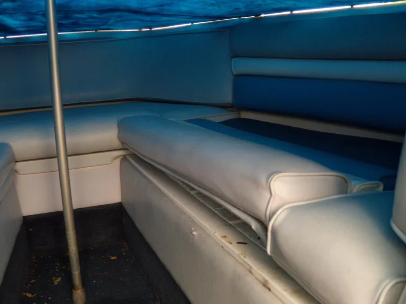Slide: The Image of Interior seating of 1989 Chaparral 2300 SX Sport boat, featuring blue upholstery. - 14