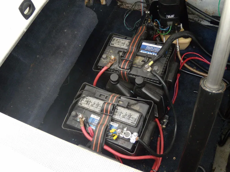 Slide: The Image of Batteries in 1989 Chaparral 2300 SX Sport boat, secured with straps and connected with cables. - 18