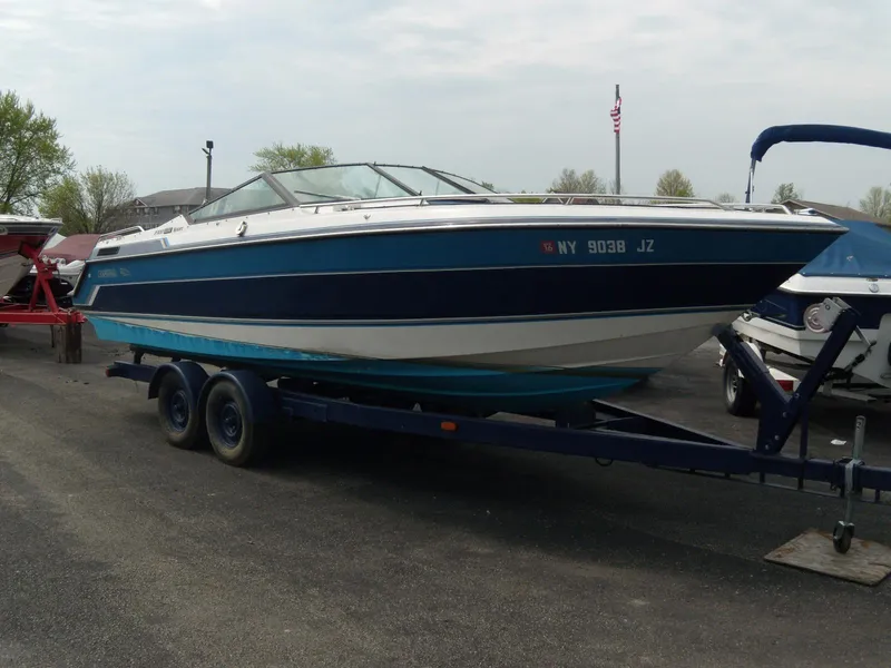Slide: The Image of 1989 Chaparral 2300 SX Sport boat on trailer, parked outdoors. - 2
