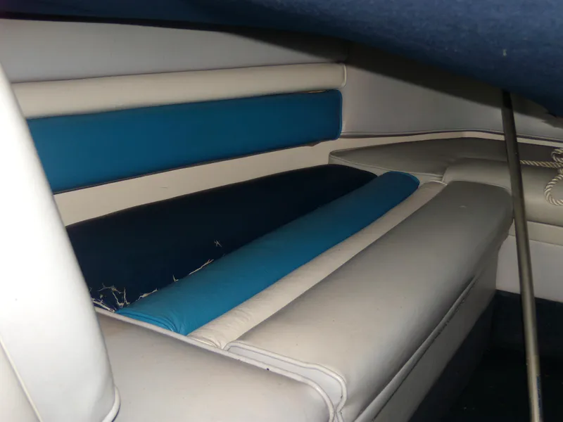 Slide: The Image of Interior seating of 1989 Chaparral 2300 SX Sport boat, featuring blue and white upholstery. - 22