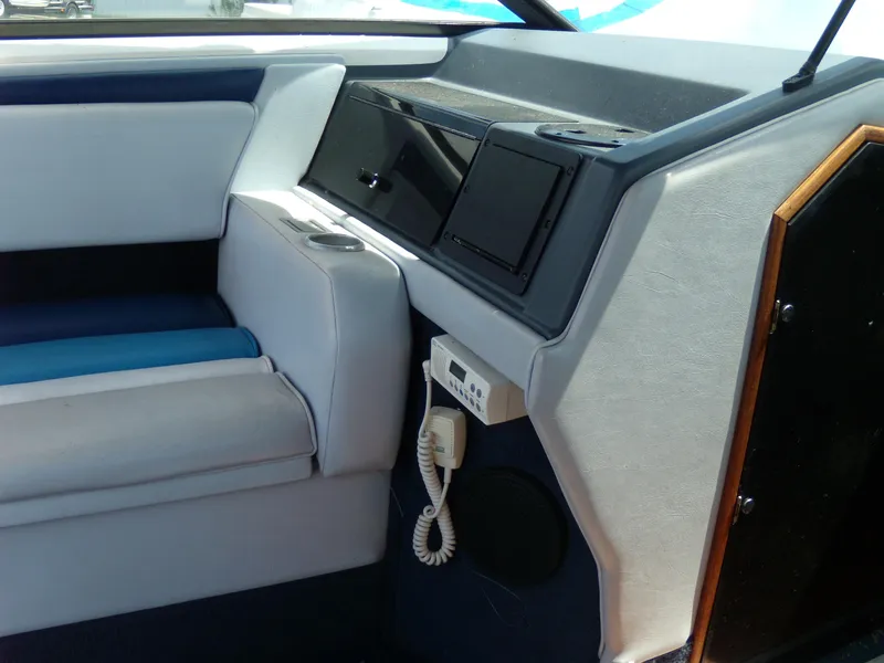Slide: The Image of Interior of 1989 Chaparral 2300 SX Sport boat with seating and control panel. - 24