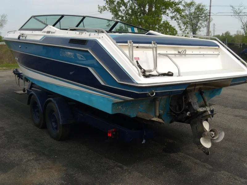 Slide: The Image of 1989 Chaparral 2300 SX Sport boat on trailer, rear view, blue and white design. - 4