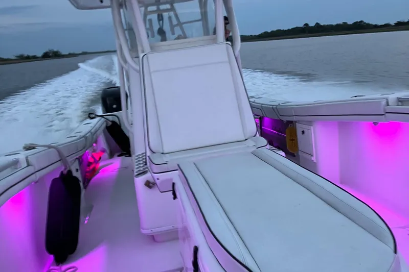 Slide: The Image of 2007 Yellowfin 36 boat with pink interior lights cruising on water. - 11