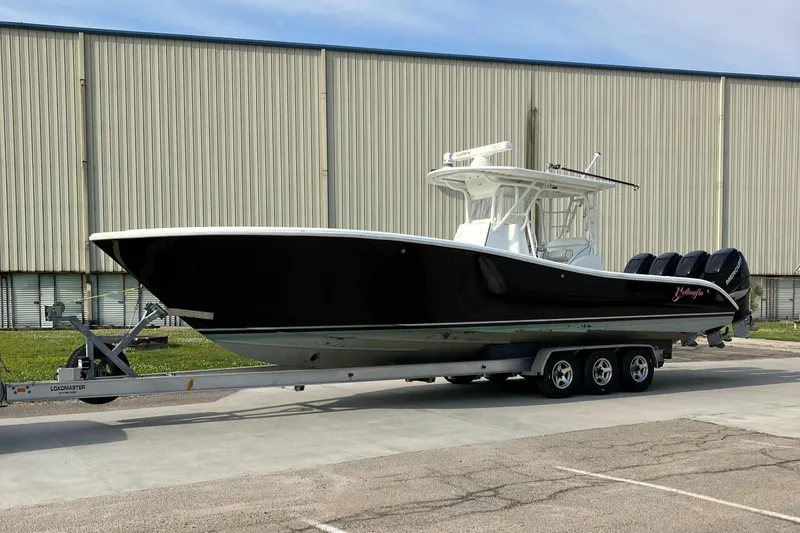 Slide: The Image of 2007 Yellowfin 36 boat on trailer, parked outdoors near a large building. - 14