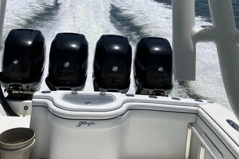 Slide: The Image of 2007 Yellowfin 36 boat with four powerful outboard engines cruising on water. - 15