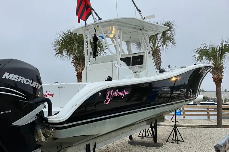 Slide: The Image of 2007 Yellowfin 36 boat with Mercury engine, docked near palm trees. - 17
