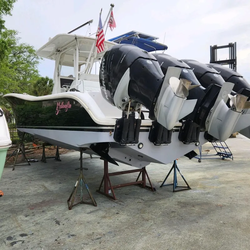 Slide: The Image of 2007 Yellowfin 36 boat with triple outboard engines on stands, American flags displayed. - 3