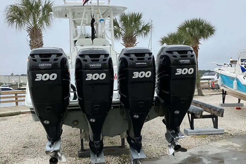 Slide: The Image of 2007 Yellowfin 36 boat with four 300 horsepower outboard engines, docked near palm trees. - 9