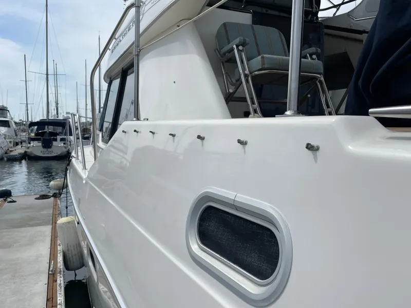 Slide: The Image of 1998 Bayliner 4087 Aft Cabin Motoryacht docked at marina, side view. - 10