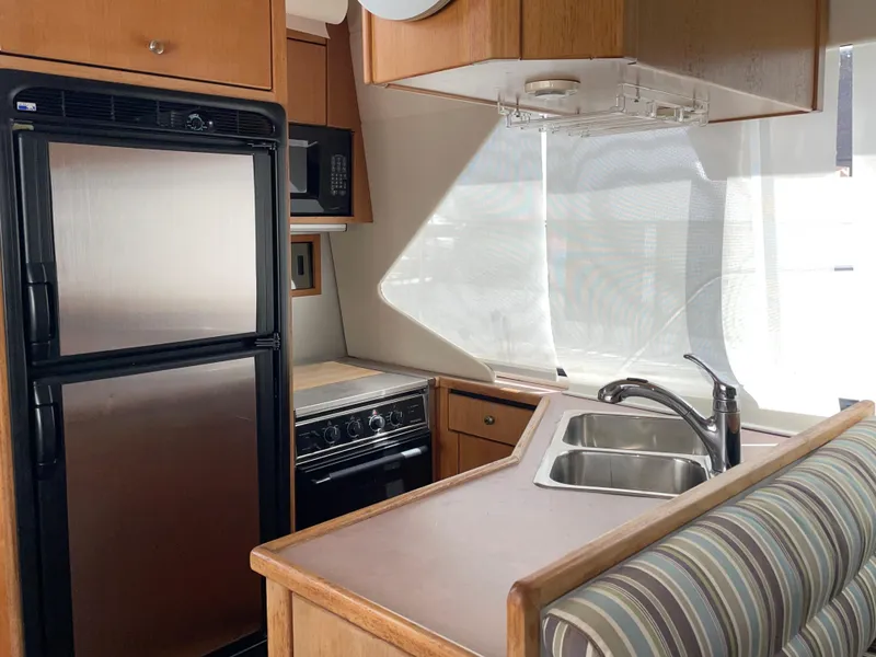 Slide: The Image of 1998 Bayliner 4087 Aft Cabin Motoryacht kitchen with fridge, stove, and sink. - 19