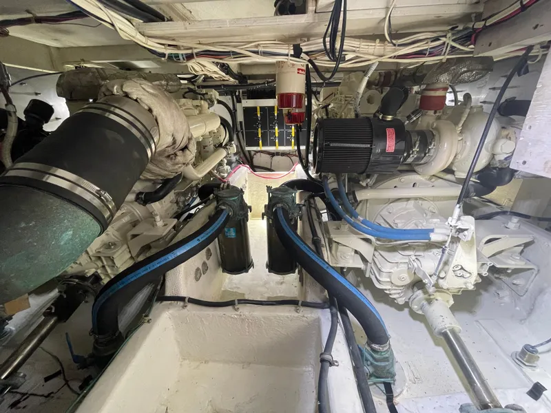 Slide: The Image of Engine room of 1998 Bayliner 4087 Aft Cabin Motoryacht, showcasing mechanical components and wiring. - 25