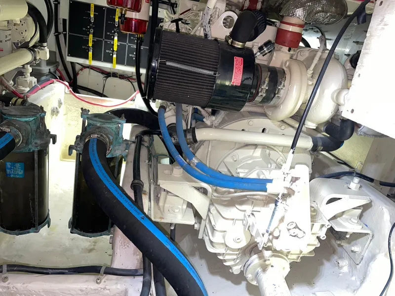 Slide: The Image of Engine room of 1998 Bayliner 4087 Aft Cabin Motoryacht with visible components and hoses. - 26